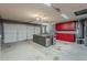Spacious two car garage with lots of storage options, gray paint and an island workbench in the middle at 1391 W Windhaven Ave, Gilbert, AZ 85233