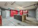 Inside the garage, discover a spacious area featuring built-in cabinets, a workbench, and ample storage solutions at 1391 W Windhaven Ave, Gilbert, AZ 85233