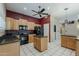 Functional kitchen featuring black appliances, granite countertops, and a central island, perfect for cooking at 1391 W Windhaven Ave, Gilbert, AZ 85233