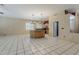 Spacious living area featuring tile floors, plantation shutters, and access to the kitchen for easy entertaining at 1391 W Windhaven Ave, Gilbert, AZ 85233