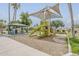 Community playground with shade sail over the play equipment as well as a covered picnic table seating area at 1391 W Windhaven Ave, Gilbert, AZ 85233