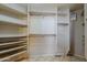 Bright walk-in closet with custom shelving and wood rods providing ample storage space at 1391 W Windhaven Ave, Gilbert, AZ 85233