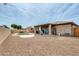 Wide backyard shot featuring a kidney-shaped pool and a covered patio area at 14752 W Evans Dr, Surprise, AZ 85379