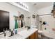 Bright bathroom featuring a dual sink vanity, large mirror, and shower-tub combo at 14752 W Evans Dr, Surprise, AZ 85379