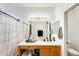 This full bathroom features a shower-tub combination and wooden vanity with a white countertop at 14752 W Evans Dr, Surprise, AZ 85379
