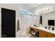 This full bathroom features a shower-tub combination and wooden vanity with a white countertop at 14752 W Evans Dr, Surprise, AZ 85379