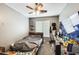 A furnished bedroom with a ceiling fan, blinds on window, desk, and carpeted flooring at 14752 W Evans Dr, Surprise, AZ 85379