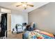 A bedroom featuring a ceiling fan, desk, closet, and a comfortable bed at 14752 W Evans Dr, Surprise, AZ 85379