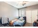 A cozy bedroom with a ceiling fan, closet, and a comfortable bed with natural light at 14752 W Evans Dr, Surprise, AZ 85379
