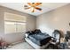 A bedroom featuring a ceiling fan, window with blinds, carpet flooring and closet at 14752 W Evans Dr, Surprise, AZ 85379
