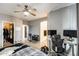 This bedroom features a ceiling fan, desk with computers, and closet for ample storage at 14752 W Evans Dr, Surprise, AZ 85379