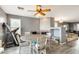 Cozy dining room featuring a fireplace, ceiling fan, and a wooden table perfect for Gathering gatherings at 14752 W Evans Dr, Surprise, AZ 85379