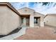 Close-up of front door entry with charming stucco wall and neutral desert landscaping at 14752 W Evans Dr, Surprise, AZ 85379