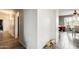 Clean hallway with light gray walls, tile flooring, and open dining space at 14752 W Evans Dr, Surprise, AZ 85379