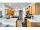 Spacious kitchen with stainless steel appliances, wood cabinets, and a cat resting on top of them at 14752 W Evans Dr, Surprise, AZ 85379