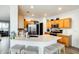 Bright kitchen with a large island, stainless steel appliances, and seating at the breakfast bar at 14752 W Evans Dr, Surprise, AZ 85379