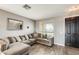 Cozy living room with a comfortable sectional sofa, wood-look flooring, and natural light at 14752 W Evans Dr, Surprise, AZ 85379