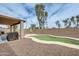 Backyard showcasing a kidney-shaped pool and covered patio area with a barbecue grill at 14752 W Evans Dr, Surprise, AZ 85379