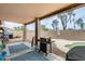 Backyard showcasing a kidney-shaped pool and covered patio area with a barbecue grill at 14752 W Evans Dr, Surprise, AZ 85379