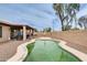 Backyard showcasing a kidney-shaped pool and covered patio area with a barbecue grill at 14752 W Evans Dr, Surprise, AZ 85379