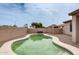 Backyard showcasing a kidney-shaped pool with tan surround and retaining wall at 14752 W Evans Dr, Surprise, AZ 85379
