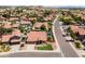 Street-level aerial view highlighting the home's manicured lawn and mature desert landscaping at 15011 S 27Th Pl, Phoenix, AZ 85048