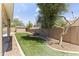 Spacious backyard featuring synthetic grass, a low-maintenance landscape, and a storage shed at 15011 S 27Th Pl, Phoenix, AZ 85048