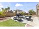 Entertainer's backyard showcasing a gazebo with seating, an outdoor fire pit, synthetic grass, and privacy walls at 15011 S 27Th Pl, Phoenix, AZ 85048