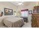 Comfortable bedroom offering a serene setting with natural light, cozy bed, and a wooden dresser with mirror at 15011 S 27Th Pl, Phoenix, AZ 85048