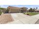 Beautiful single-story home featuring a large concrete driveway, manicured lawn and desert landscaping at 15011 S 27Th Pl, Phoenix, AZ 85048