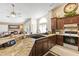 Updated kitchen with granite counters, dark wood cabinets, tile floors, and open floor plan to the living space at 15011 S 27Th Pl, Phoenix, AZ 85048