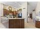 Spacious kitchen featuring dark wood cabinetry, granite countertops, stainless steel appliances, and tile flooring at 15011 S 27Th Pl, Phoenix, AZ 85048