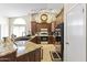 Well-equipped kitchen with granite countertops, dark wood cabinetry, tile flooring, and stainless steel appliances at 15011 S 27Th Pl, Phoenix, AZ 85048