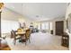 Open-concept living space features neutral walls, carpet flooring, and large windows for natural light at 15011 S 27Th Pl, Phoenix, AZ 85048