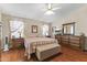 Cozy main bedroom featuring hardwood floors, a ceiling fan, and coordinated furnishings at 15011 S 27Th Pl, Phoenix, AZ 85048