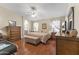 Comfortable main bedroom featuring hardwood floors, a ceiling fan, and coordinated furnishings at 15011 S 27Th Pl, Phoenix, AZ 85048