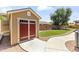 Backyard shed with painted doors, concrete path, and decorative trim is perfect for storage at 15011 S 27Th Pl, Phoenix, AZ 85048
