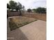 Backyard features a block wall, brick pavers, and space for outdoor activities and entertaining at 15446 W Jenan Dr, Surprise, AZ 85379