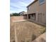 Backyard features a block wall, room for activities and entertaining, and access to the home at 15446 W Jenan Dr, Surprise, AZ 85379