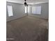 Large bedroom with carpet, ceiling fan, and natural light at 15446 W Jenan Dr, Surprise, AZ 85379