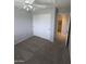 Neutral toned bedroom with gray carpet, closet, ceiling fan and neutral paint at 15446 W Jenan Dr, Surprise, AZ 85379