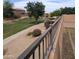 Community park features walking paths, grassy areas, mature trees, and playground in the background at 15446 W Jenan Dr, Surprise, AZ 85379