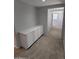 A bright hallway featuring neutral paint, built-in storage and plush carpet at 15446 W Jenan Dr, Surprise, AZ 85379
