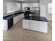 Modern kitchen with granite countertops, stainless steel appliances, and white cabinets at 15446 W Jenan Dr, Surprise, AZ 85379