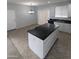 Open kitchen with black countertops and a dining area at 15446 W Jenan Dr, Surprise, AZ 85379