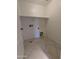 Bright laundry room features tile flooring, open shelving, and utility connections for washer and dryer at 15446 W Jenan Dr, Surprise, AZ 85379