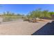 This backyard has rock landscaping, perimeter fencing, and minimal foliage at 15806 N 107Th Pl, Scottsdale, AZ 85255
