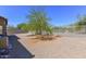 Low-maintenance backyard with desert landscaping, gravel, trees, and perimeter fencing at 15806 N 107Th Pl, Scottsdale, AZ 85255