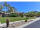 Manicured backyard with green grass, desert landscaping, and mountain views at 15806 N 107Th Pl, Scottsdale, AZ 85255