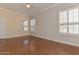 Bright bedroom featuring hardwood floors, shuttered windows, and neutral paint colors at 15806 N 107Th Pl, Scottsdale, AZ 85255